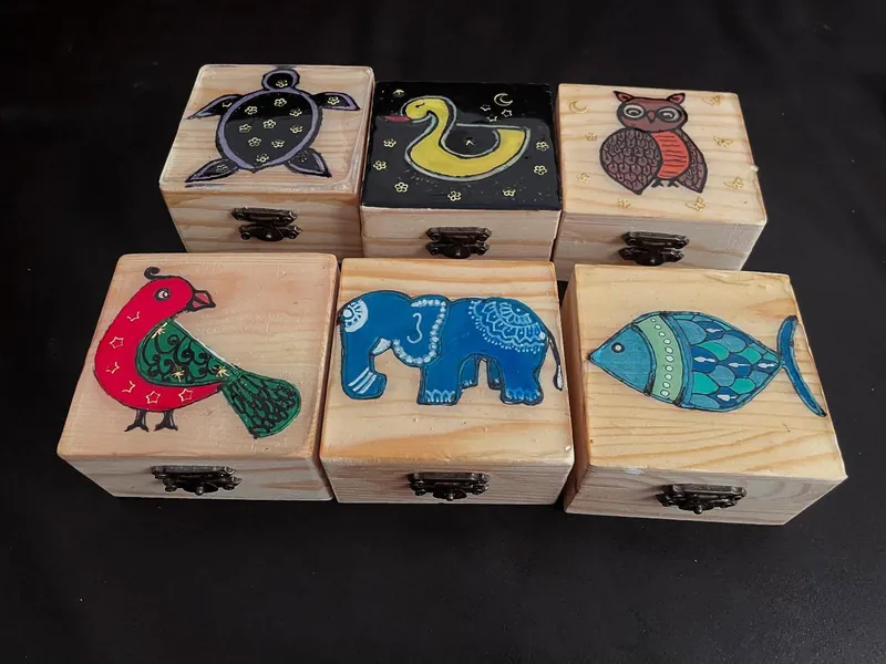 Six small wooden boxes painted with a turtle, duck, owl, bird, elephant and fish