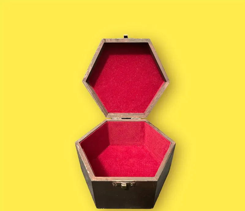 Hexagonal jewellery box open, showing red velvet lining